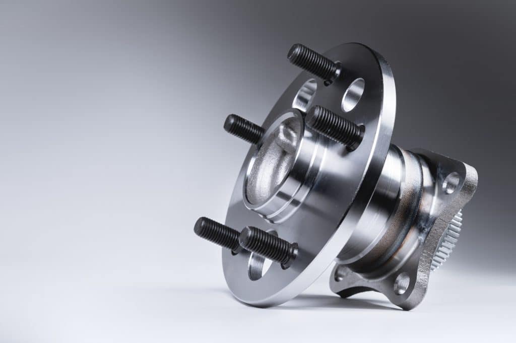 new wheel hub assembly with bearing this is part of the car suspension on a gray background with a gradient the concept of new car parts